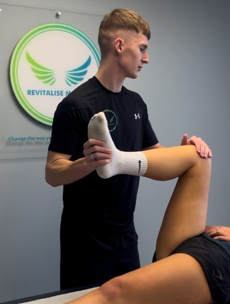 Sports and clinical therapist performing a hip assessment for hip pain treatment in Monmouthshire